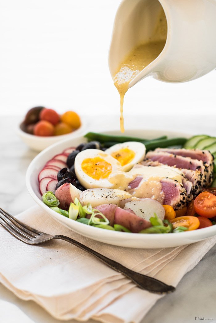 Perfectly seared sesame crusted ahi tuna on a bed of fresh veggies, topped with a creamy egg, and drizzled with a finger-licking good vinaigrette, gives this Nicoise Salad a 'WOW' factor!