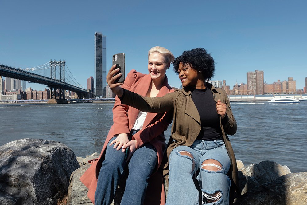 Women taking photos on their cell phones